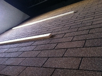 Roof shingles with two wooden beams.